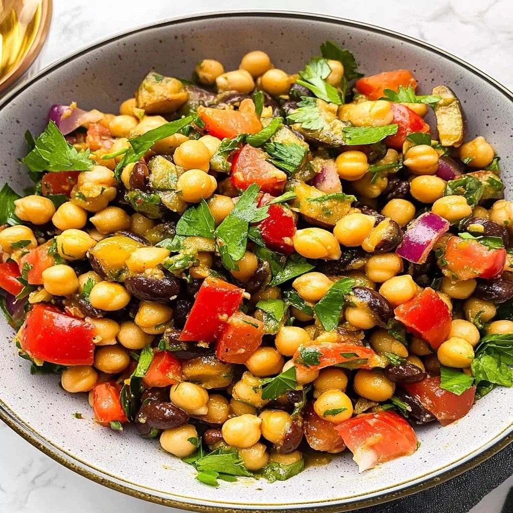 Colorful garbanzo bean salad with fresh vegetables and dressing