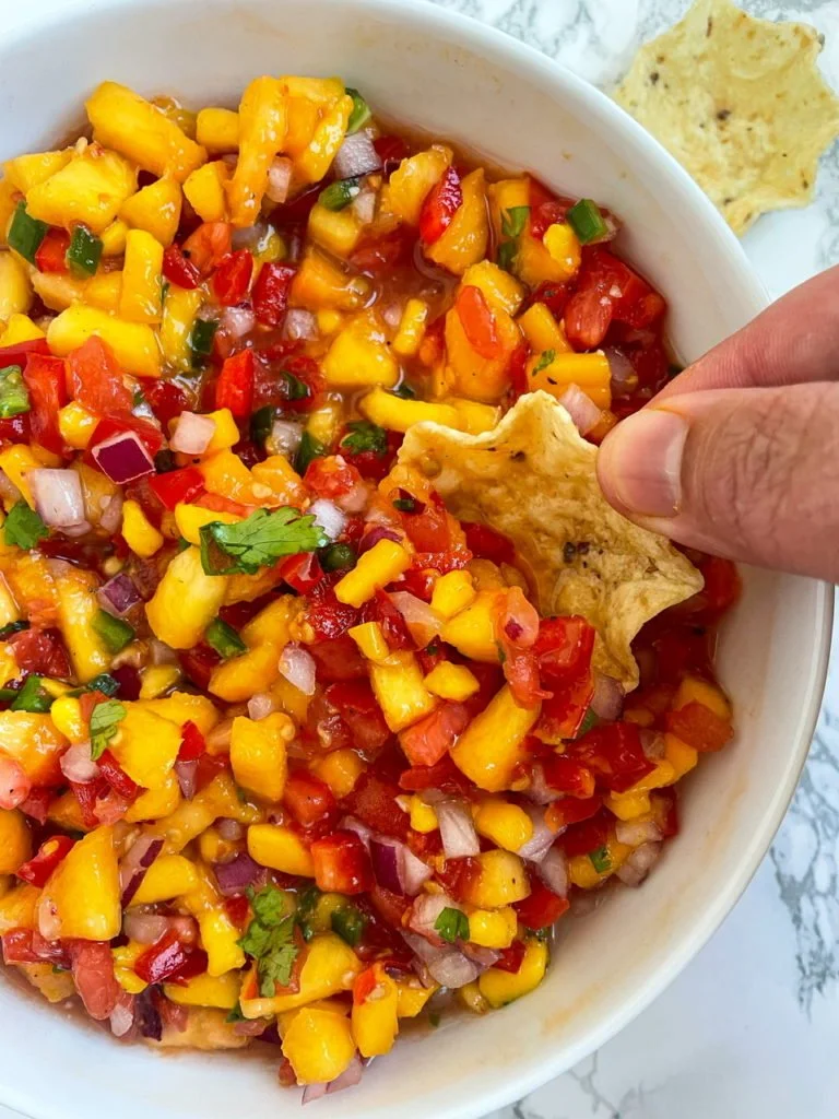 Fresh peach mango salsa in a decorative bowl