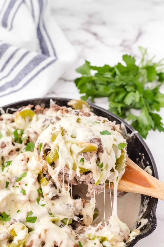 Delicious Philly Cheesesteak Casserole topped with melted cheese and peppers.