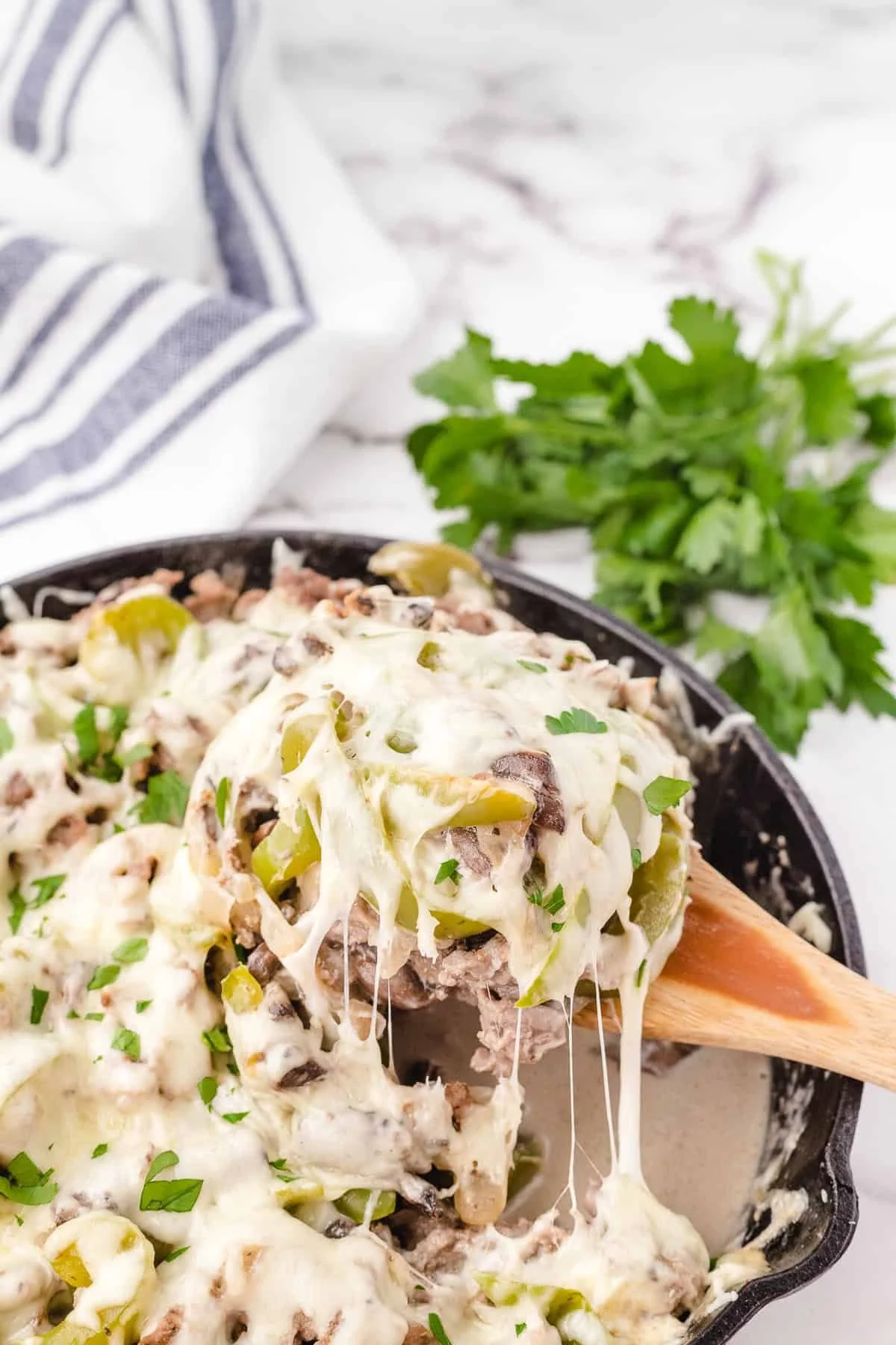 Delicious Philly Cheesesteak Casserole topped with melted cheese and peppers.