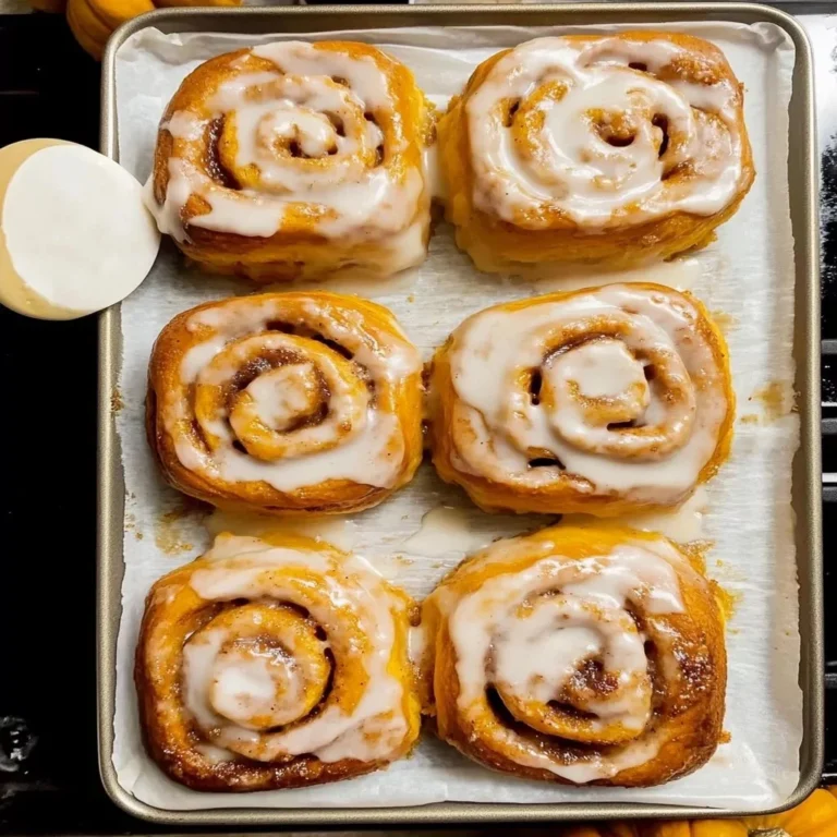 Delicious Pumpkin Cinnamon Rolls topped with cream cheese frosting