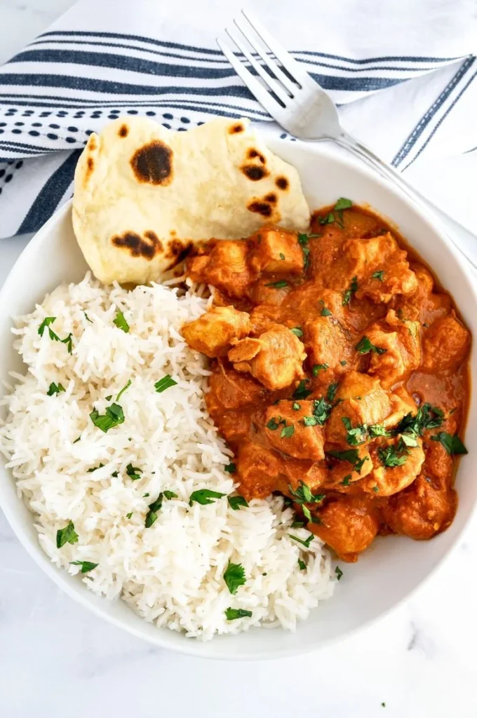 Crockpot quick-prep butter chicken dish served in a bowl with rice