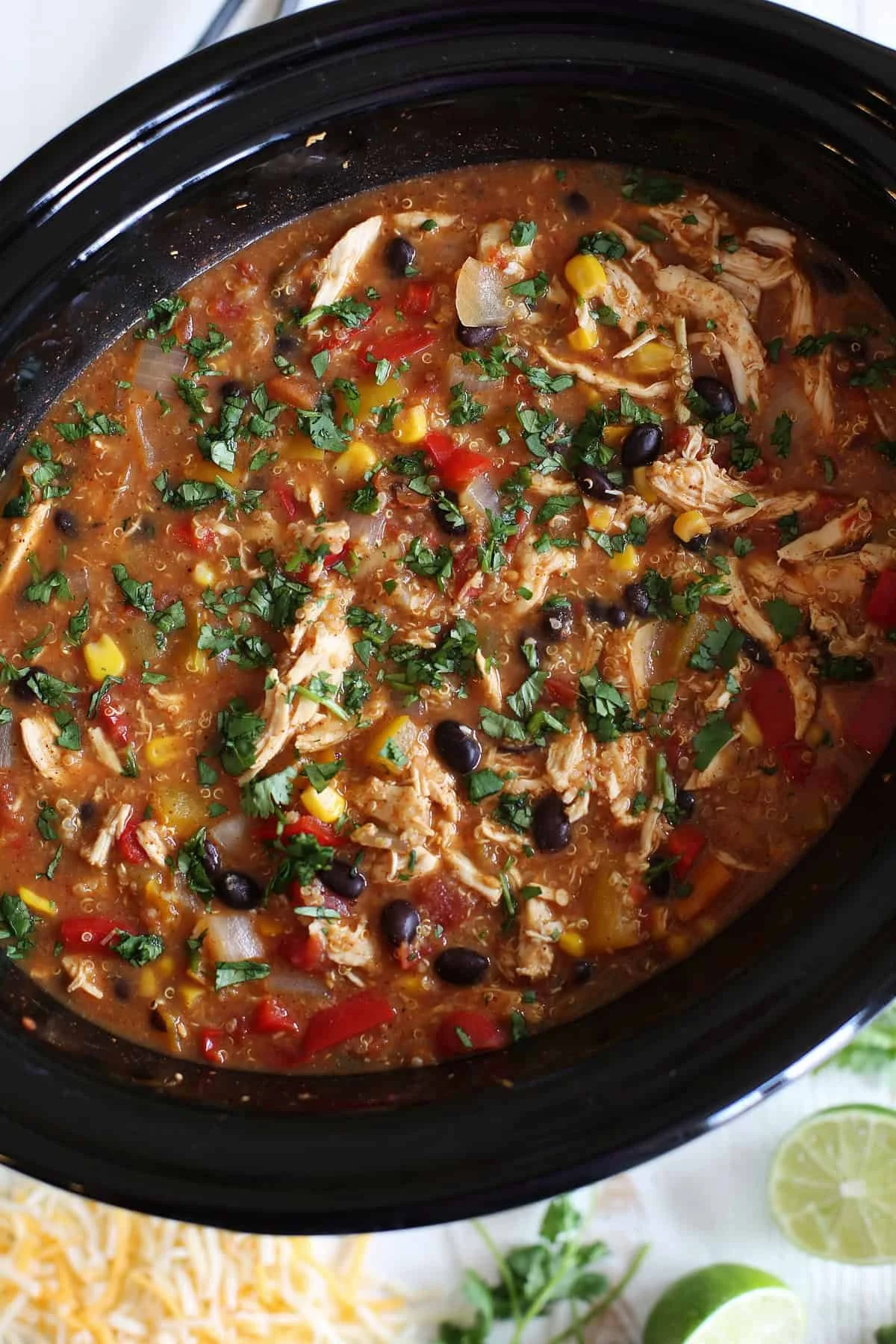 Bowl of slow cooker chicken fajita soup with quinoa and colorful vegetables