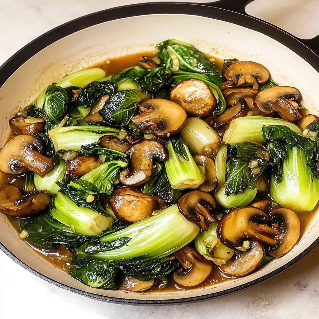 Bok choy and mushroom stir fry with colorful vegetables served in a bowl.