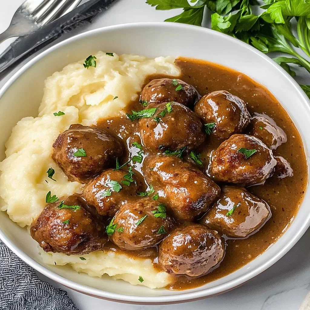 Crockpot meatballs simmering in rich gravy for a delicious meal