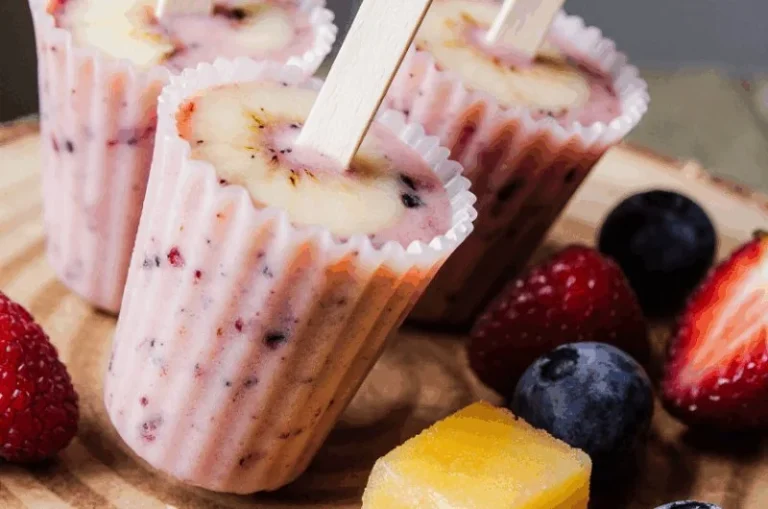 Colorful frozen yogurt fruit pops with various fruits for a refreshing snack