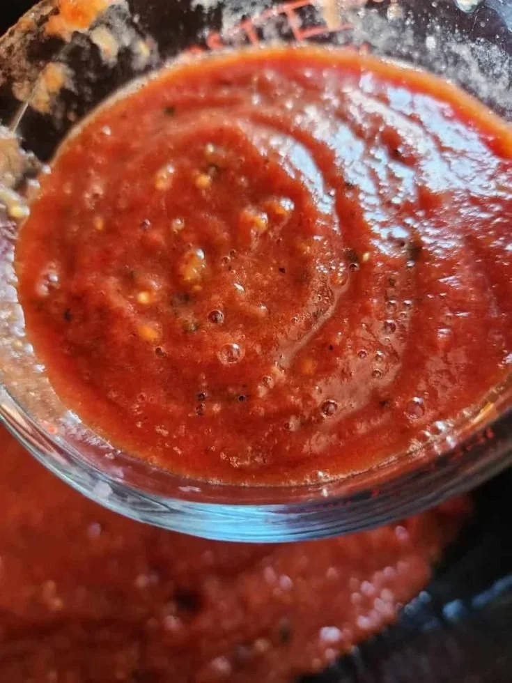 Delicious homemade roasted tomato spaghetti sauce in a jar ready for canning