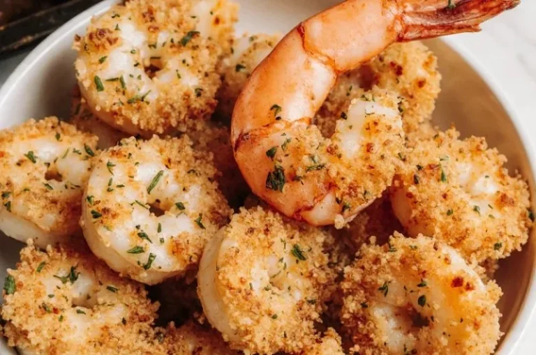 Plate of crispy baked shrimp garnished with herbs and lemon slices