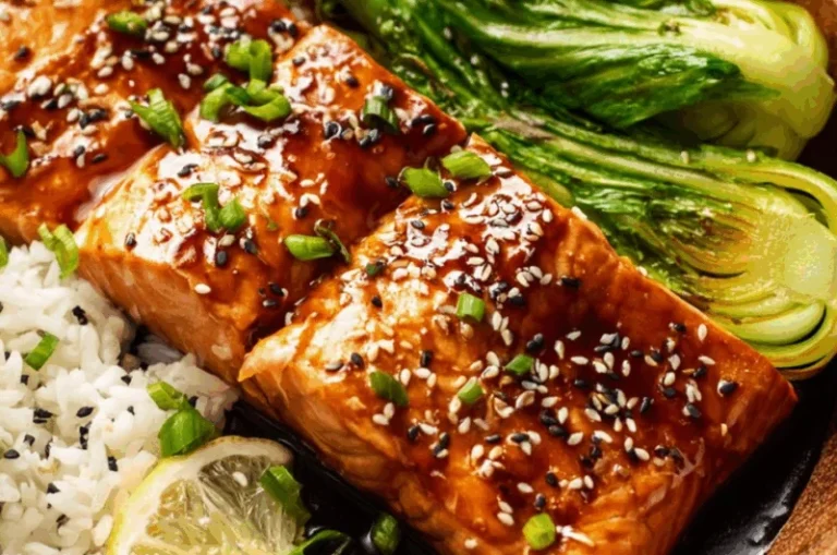 A beautifully plated miso glazed salmon dish garnished with green onions.