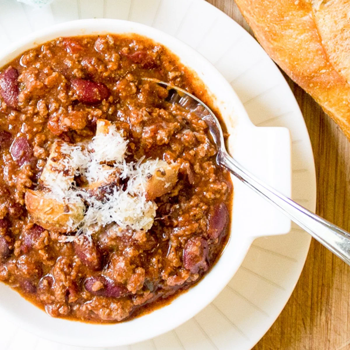 Delicious stovetop chili simmering in a pot, garnished with fresh cilantro.