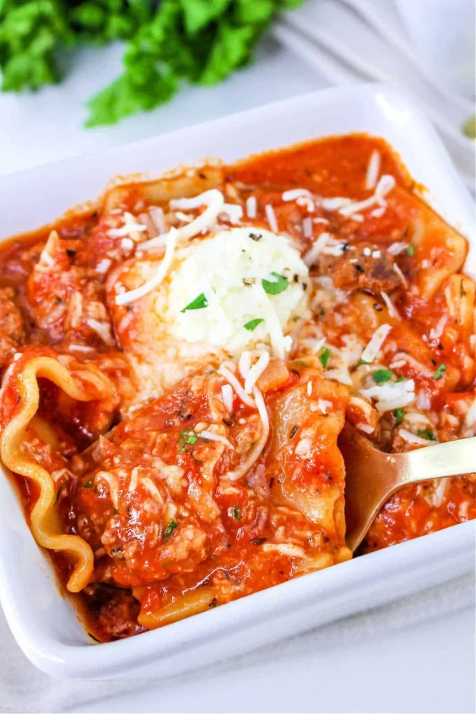 Bowl of one pot lasagna soup topped with fresh herbs and cheese