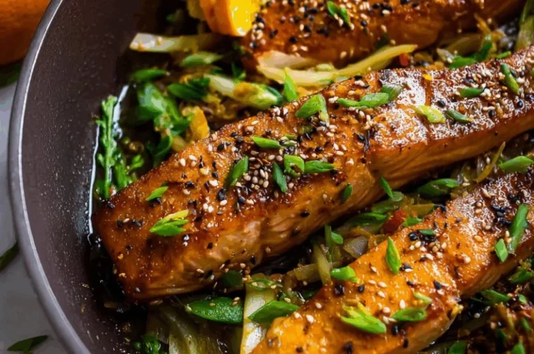 Orange Ginger Salmon Skillet dish served in a frying pan with vibrant garnishing.