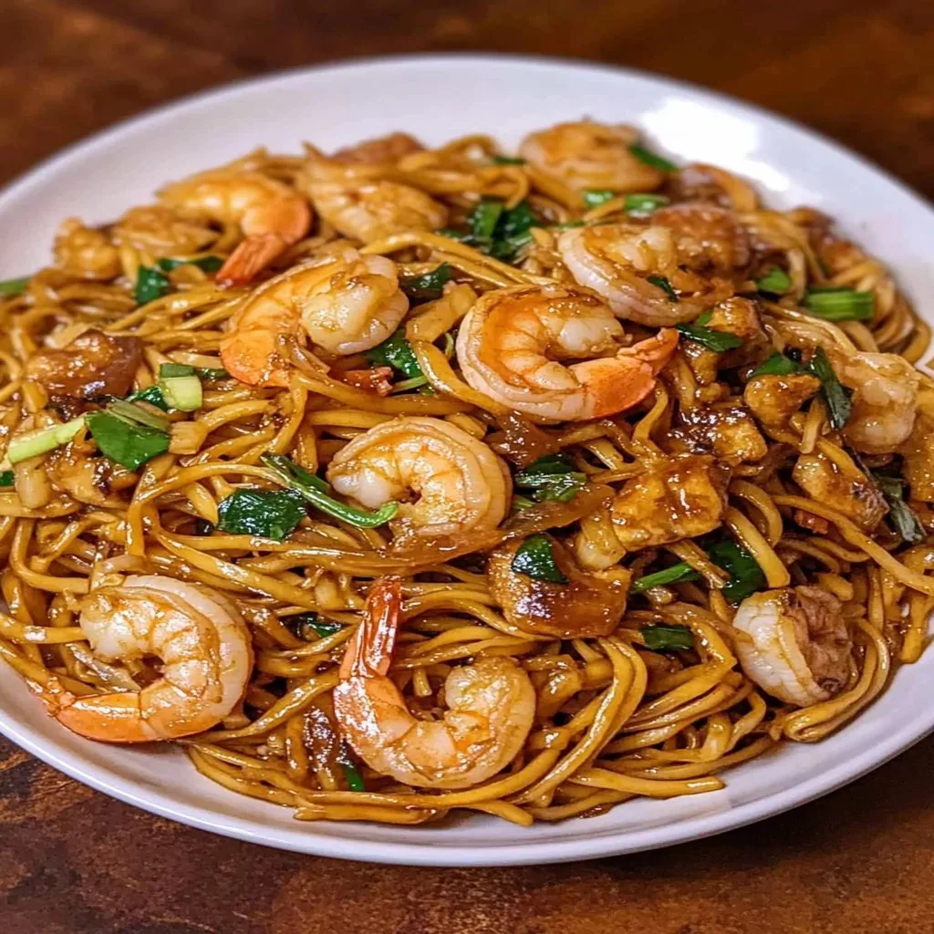 Colorful shrimp stir fry with noodles and vegetables in a bowl